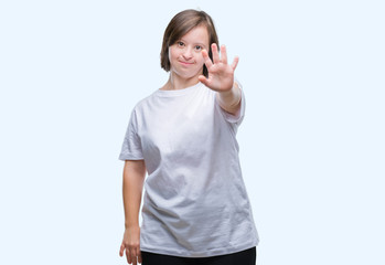 Wall Mural - Young adult woman with down syndrome over isolated background doing stop sing with palm of the hand. Warning expression with negative and serious gesture on the face.