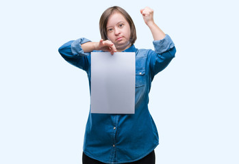 Sticker - Young adult woman with down syndrome holding blank paper sheet over isolated background annoyed and frustrated shouting with anger, crazy and yelling with raised hand, anger concept