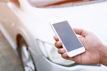 close up male hand using a mobile smart phone call a car mechanic ask for help assistance because car broken on the roadside. blank of empty screen.