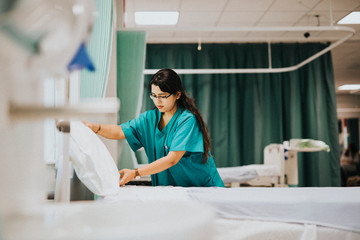 Nurse making the bed at a hospital