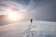 © Mumemories - Man mountaineer walking with snow footprint on peak ridge