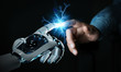 © sdecoret - Robot hand creating electricity with human hand 3D rendering
