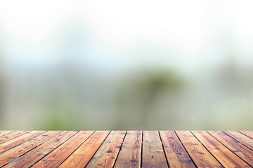 Wall Mural - City concept: Wood table top on blur glass window wall building background