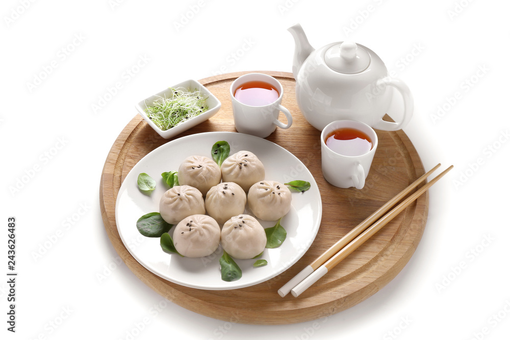 Composition with tasty Chinese dumplings and tea on white background
