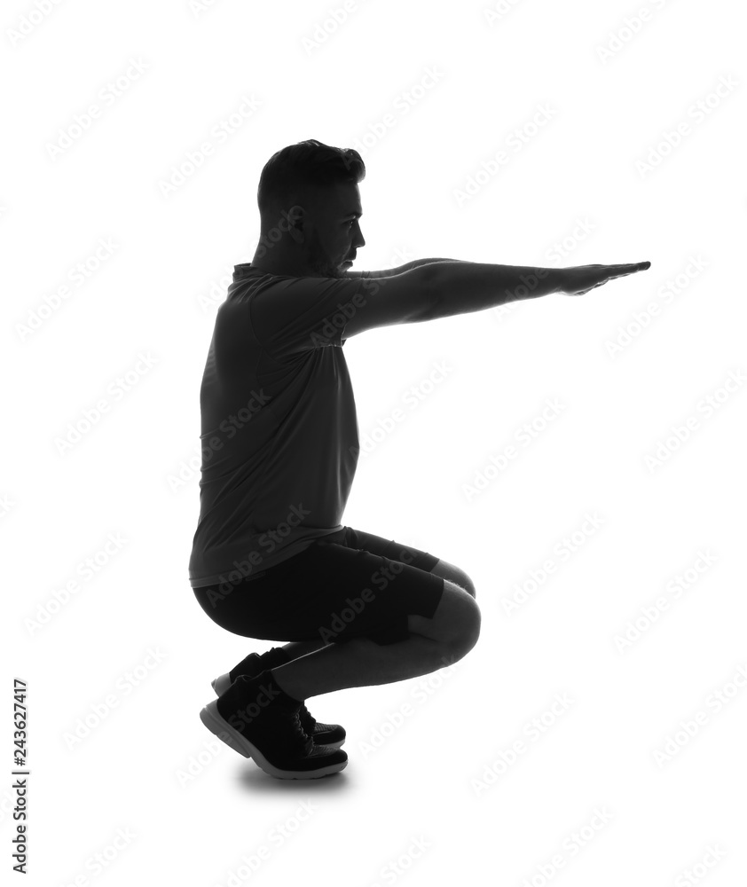 Silhouette of sporty man doing a squats on white background