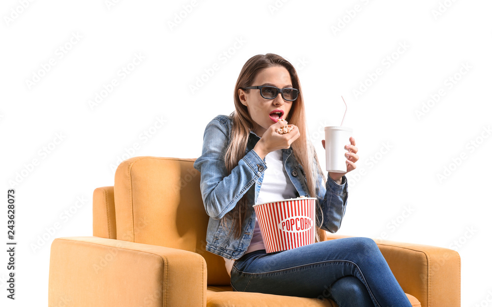 Young woman with popcorn watching movie on white background