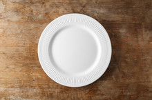 Empty Ceramic Plate On Wooden Background