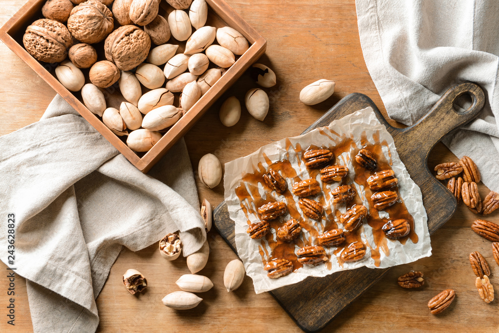 Tasty pecan nuts on wooden table