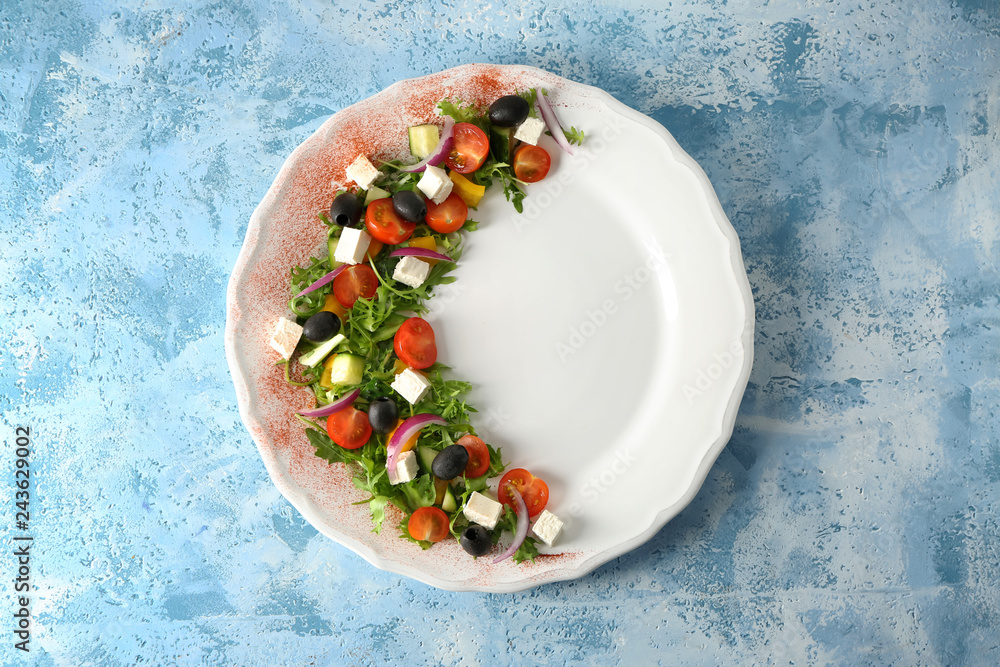 Plate with tasty salad on color background