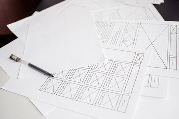 Wall Mural - ux website designer drawing wireframe sketch of prototype, framework, layout future project. creativ