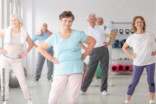 Group of happy seniors during sport\'s training at gym