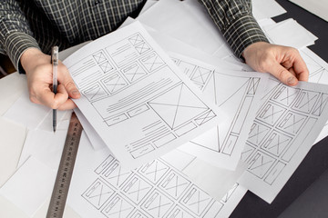 Wall Mural - ux website designer drawing wireframe sketch of prototype, framework, layout future project. creativ