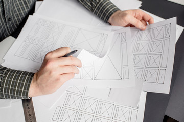 Wall Mural - ux website designer drawing wireframe sketch of prototype, framework, layout future project. creativ