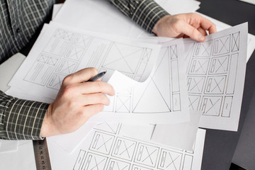 Wall Mural - ux website designer drawing wireframe sketch of prototype, framework, layout future project. creativ