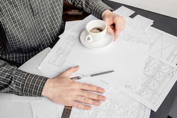Wall Mural - ux website designer drawing wireframe sketch of prototype, framework, layout future project. creativ