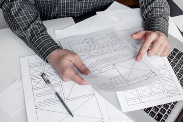 Wall Mural - ux website designer drawing wireframe sketch of prototype, framework, layout future project. creativ