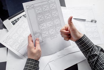 Wall Mural - ux website designer drawing wireframe sketch of prototype, framework, layout future project. creativ