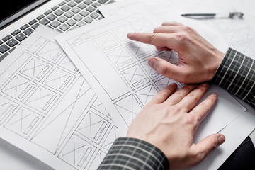 Wall Mural - ux website designer drawing wireframe sketch of prototype, framework, layout future project. creativ