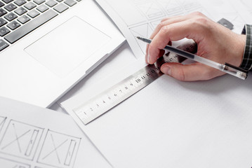 Wall Mural - ux website designer drawing wireframe sketch of prototype, framework, layout future project. creativ