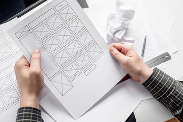 Wall Mural - ux website designer drawing wireframe sketch of prototype, framework, layout future project. creativ