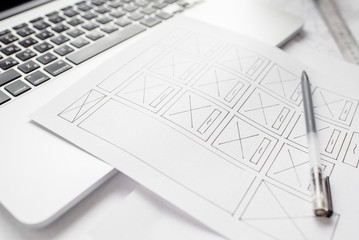 Wall Mural - ux website designer drawing wireframe sketch of prototype, framework, layout future project. creativ