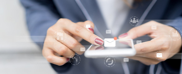 close up businesswoman holding smartphone and checking email online on web with virtual interface technology concept	
