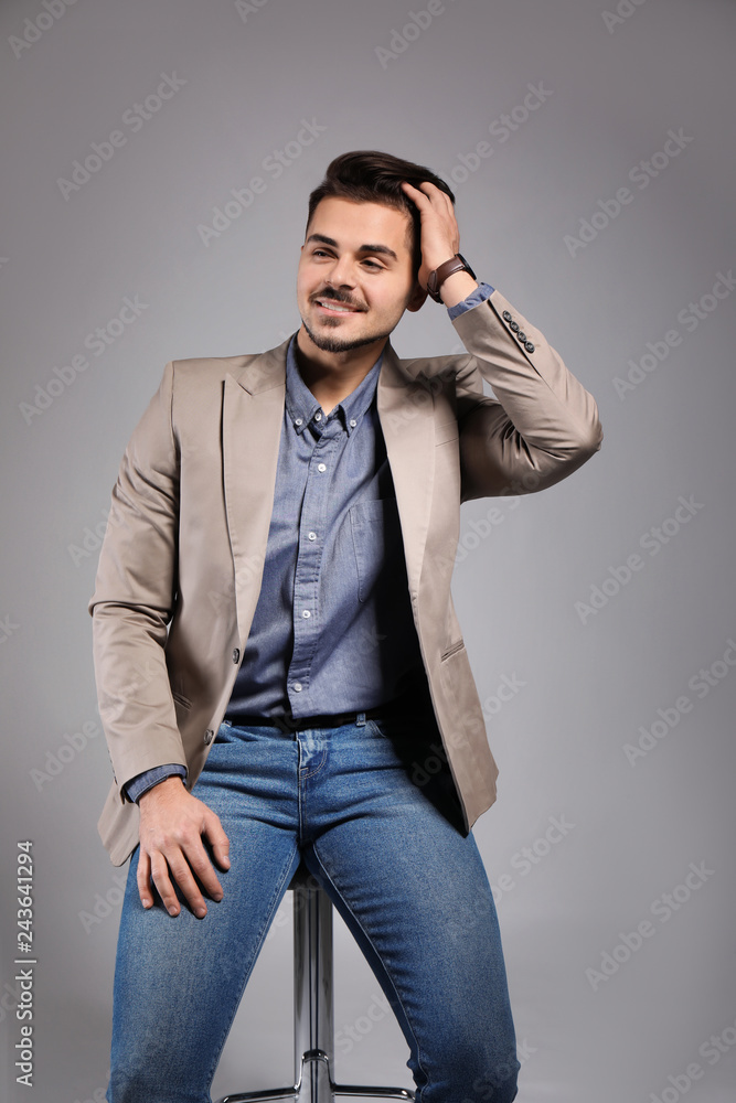 Handsome young man on grey background