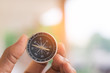 © TECHNOLOGY FACTORY - holding compass on blurred background. Using wallpaper or background travel