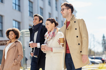 Sticker - business, education and corporate people concept - office workers or friends with coffee cups talking on city street