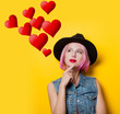 © Masson - Portrait of young style hipster girl with pink hair style on yellow background