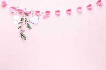 Colorful paper garland of hearts on the living coral background. Valentine day greeting cards.