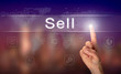 A hand selecting a Sell business concept on a clear screen with a colorful blurred background.
