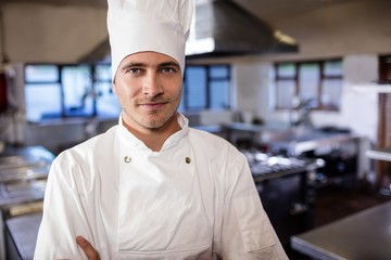 Wall Mural - Male chef standing in kitchen at hotel