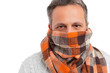 Man protecting nose and mouth with scarf.