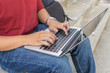 © Quang - Close-up of human hands typing on laptop keyboard