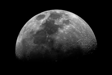 Wall Mural - first quarter moon isolated in the dark space, with its craters and shadows, taken with telescope.