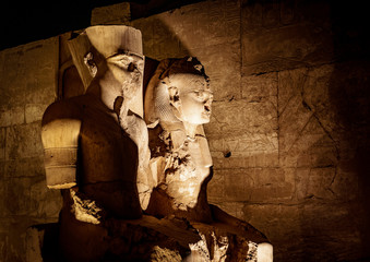 Wall Mural - Statue of King Tutankhamen and his Queen at Temple of Luxor in Luxor city (Thebes) in Egypt, illuminated at night