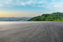 Panoramic City Skyline And Buildings With Empty Asphalt Road At Sunrise