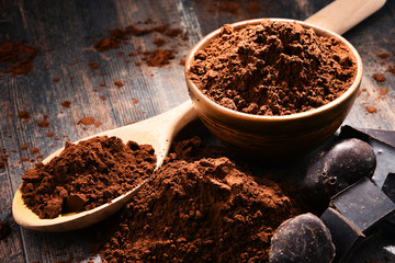 Wall Mural - Composition with bowl of cocoa powder on wooden table