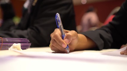 Wall Mural - document report and education concept: teacher woman hands holding pen for checking signing and note