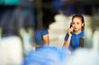 © DragonImages - Pretty female shop assistnat consulting customer on the phone