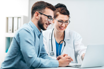 Wall Mural - Young Intern at the Hospital Completes Task