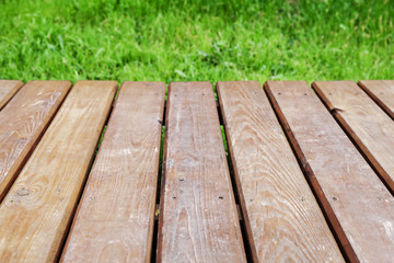 Wall Mural - Perspective view of wooden table over lawn