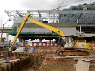 Wall Mural - KUALA LUMPUR, MALAYSIA -MARCH 16, 2017: Excavation and ground levelling work using excavator machine and other heavy construction machinery at the construction site.   