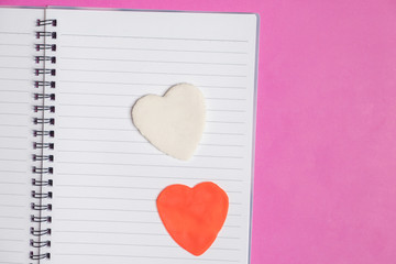 Big 2 hearts in blank book on pink background with space for text, Love icon, valentine's day, relationships concept