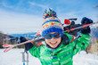 Cute skier boy in a winter ski resort.