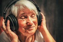 Old Woman In Headphones Listening To Music