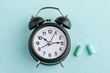 © yuriygolub - Alarm clock and earplugs