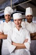 © WavebreakMediaMicro - Group of chefs standing with arms crossed in kitchen