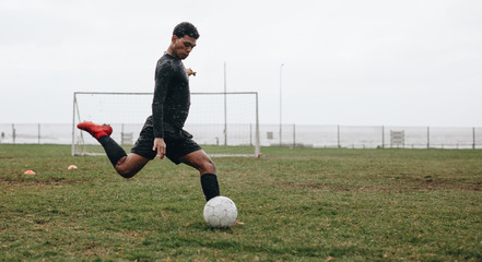 Soccer player practicing on field